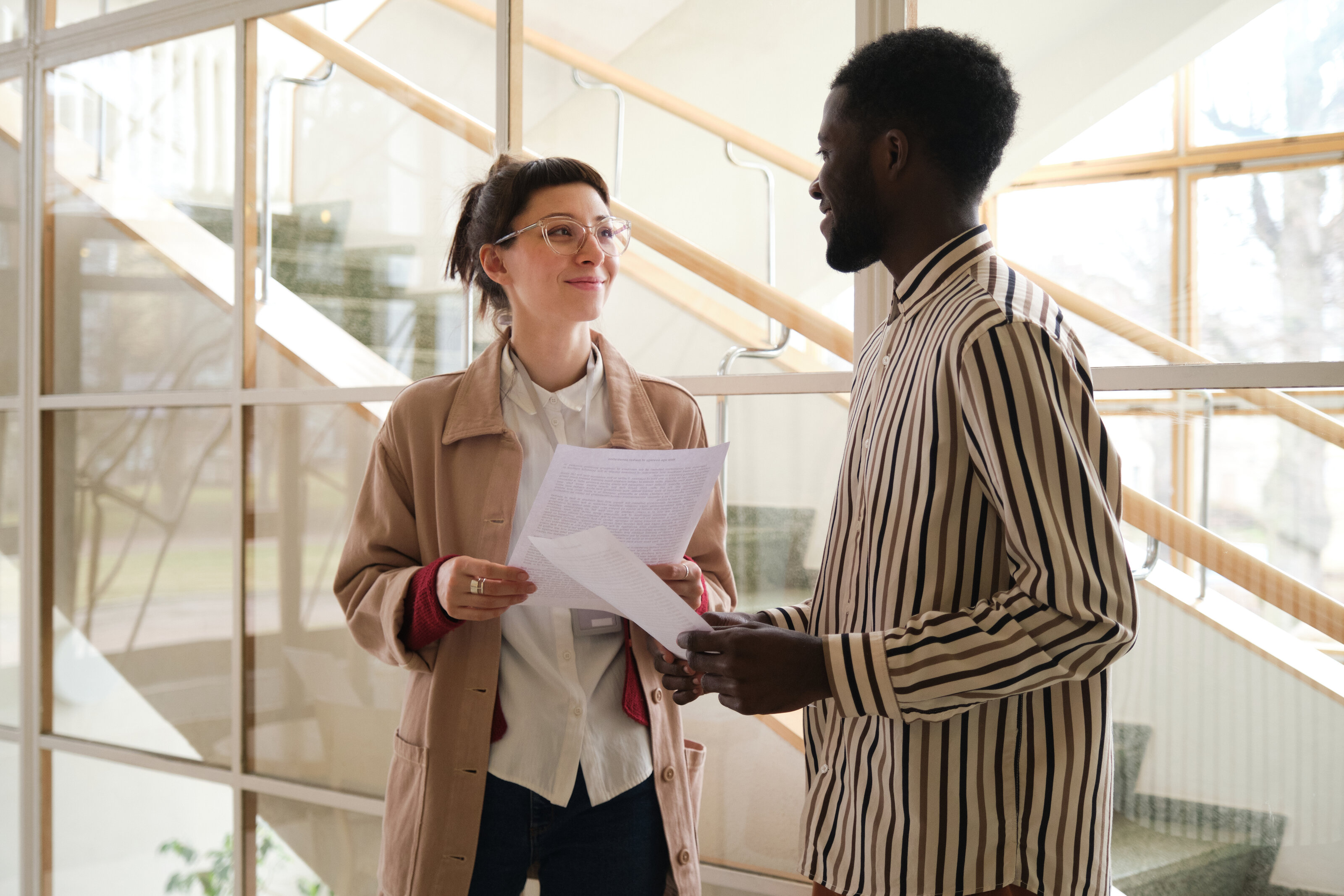 Two business partners reviewing a document together in an office