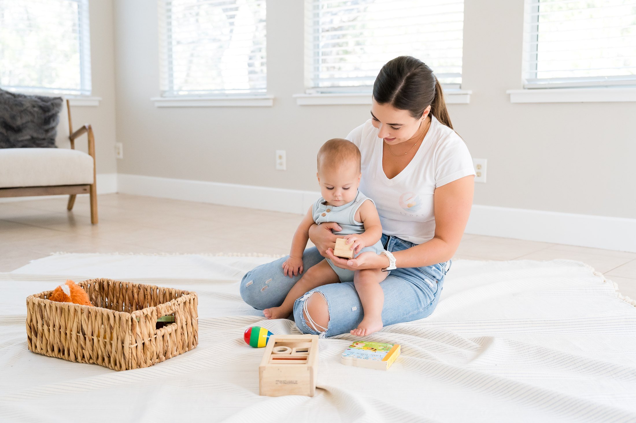 Nanny playing with an infant for Stork Maternity Consulting