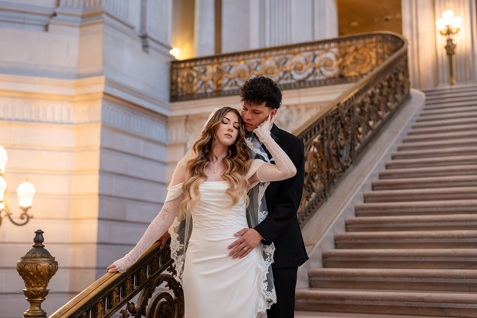 Couple embracing on the staircase at San Francisco City Hall