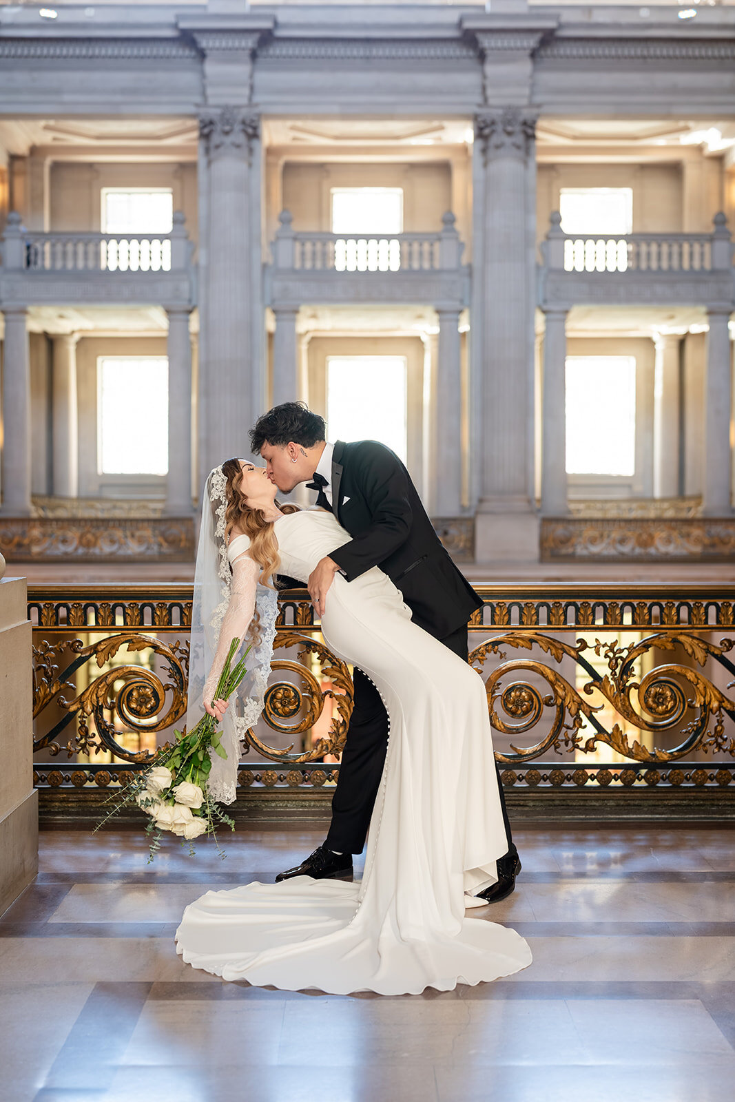 Evelyn and Armando sharing a dip kiss at SF City Hall