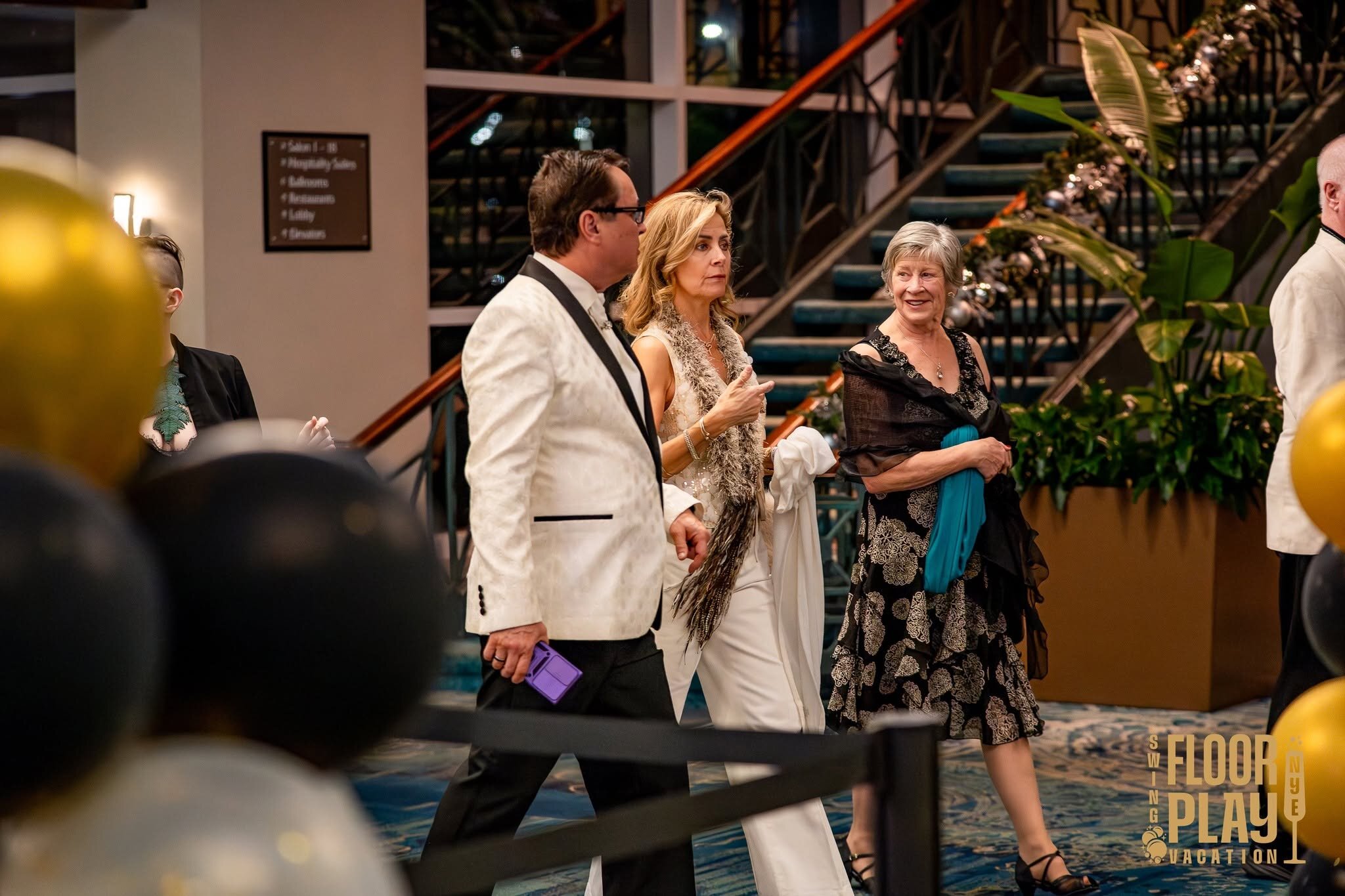 Dressed-up guests socializing in the hotel hall at a past Floorplay dinner