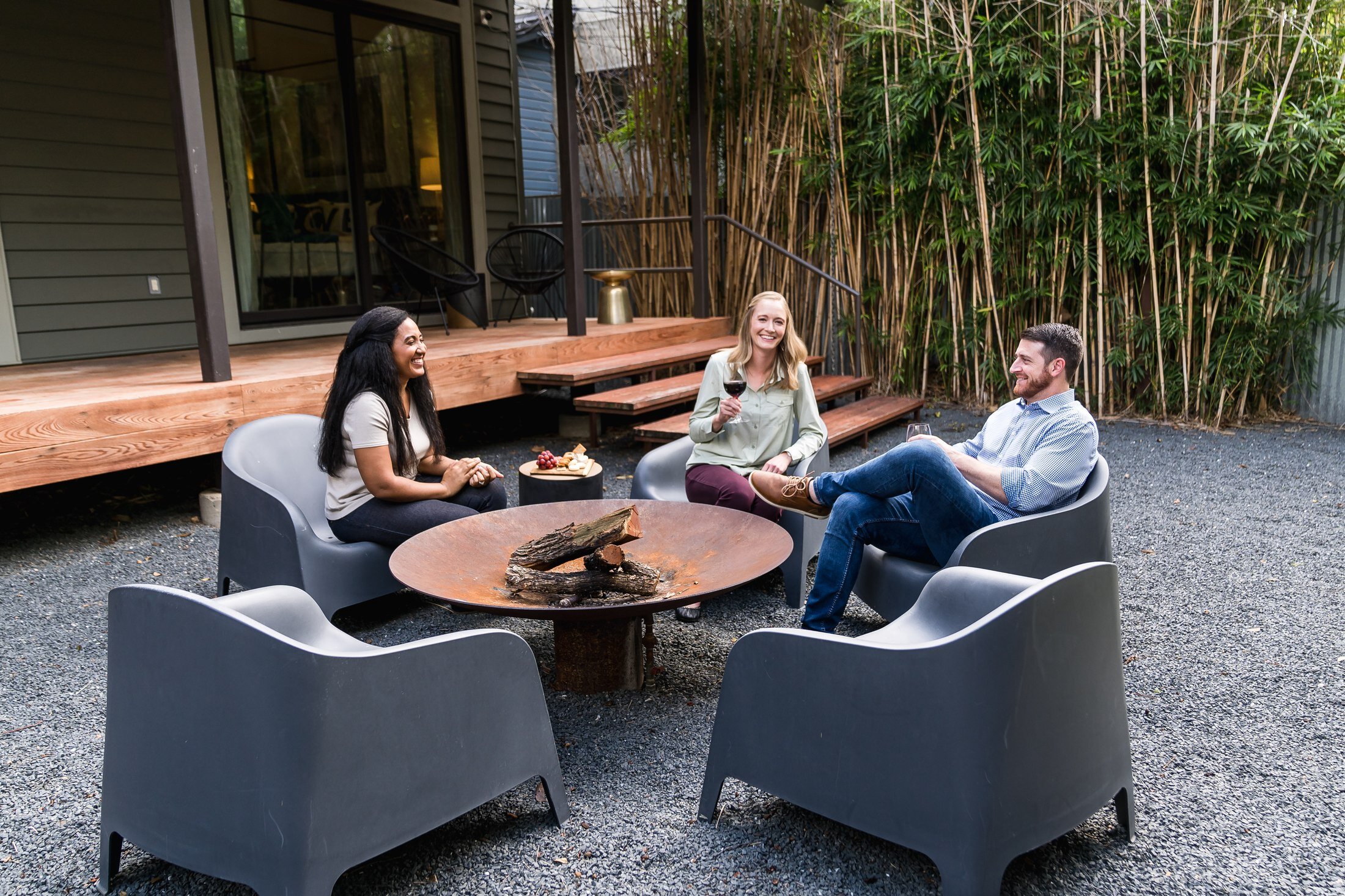 Guests gathered around a firepit at a Vacasa vacation rental in Austin