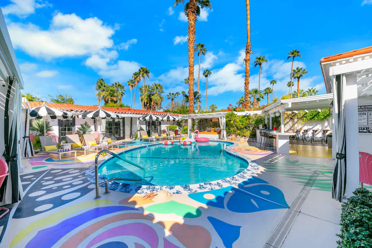 Pool courtyard with striped umbrellas