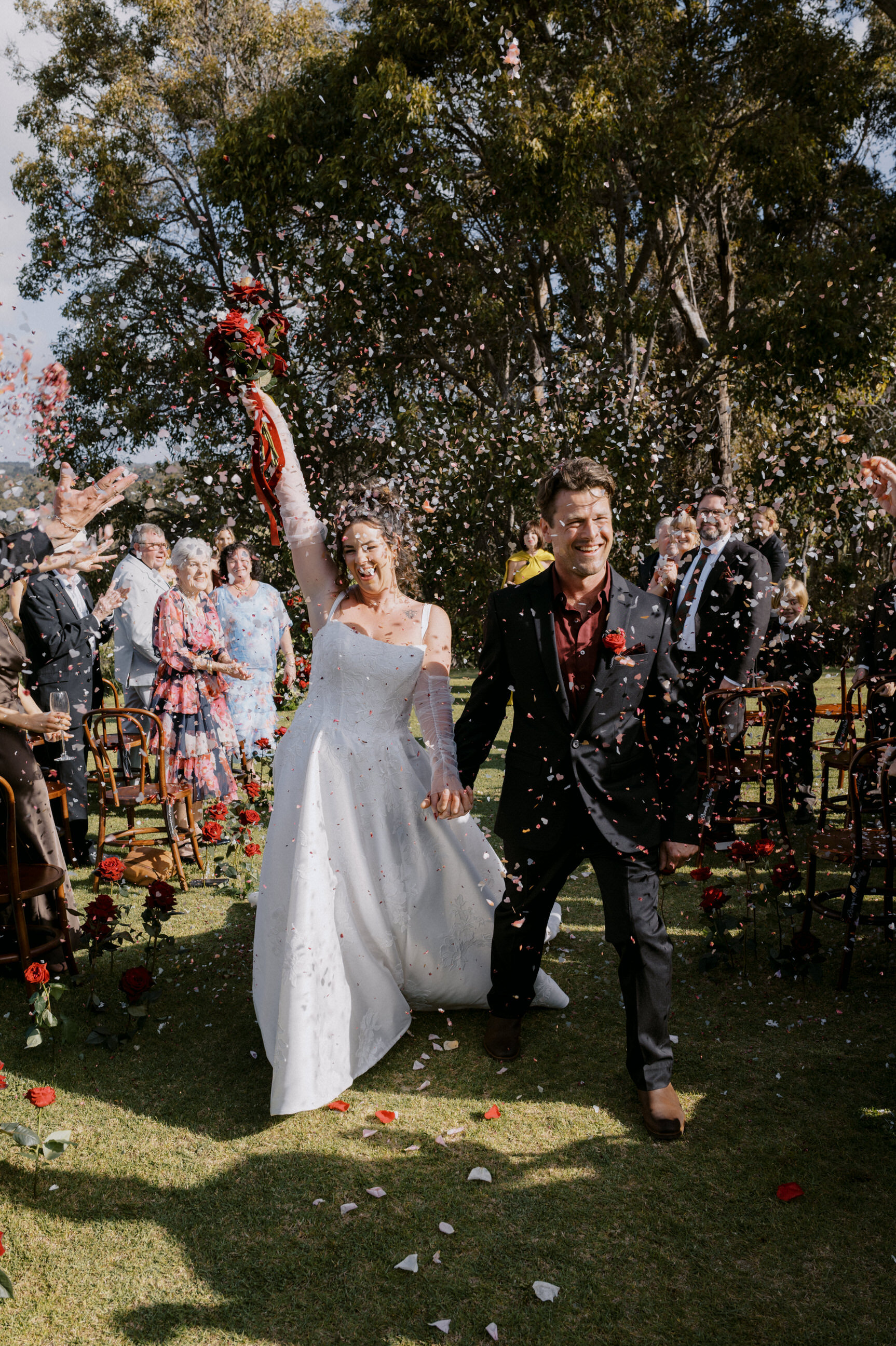 Newly married couple walking back down the aisle at Credaro Family Estate in Yallingup