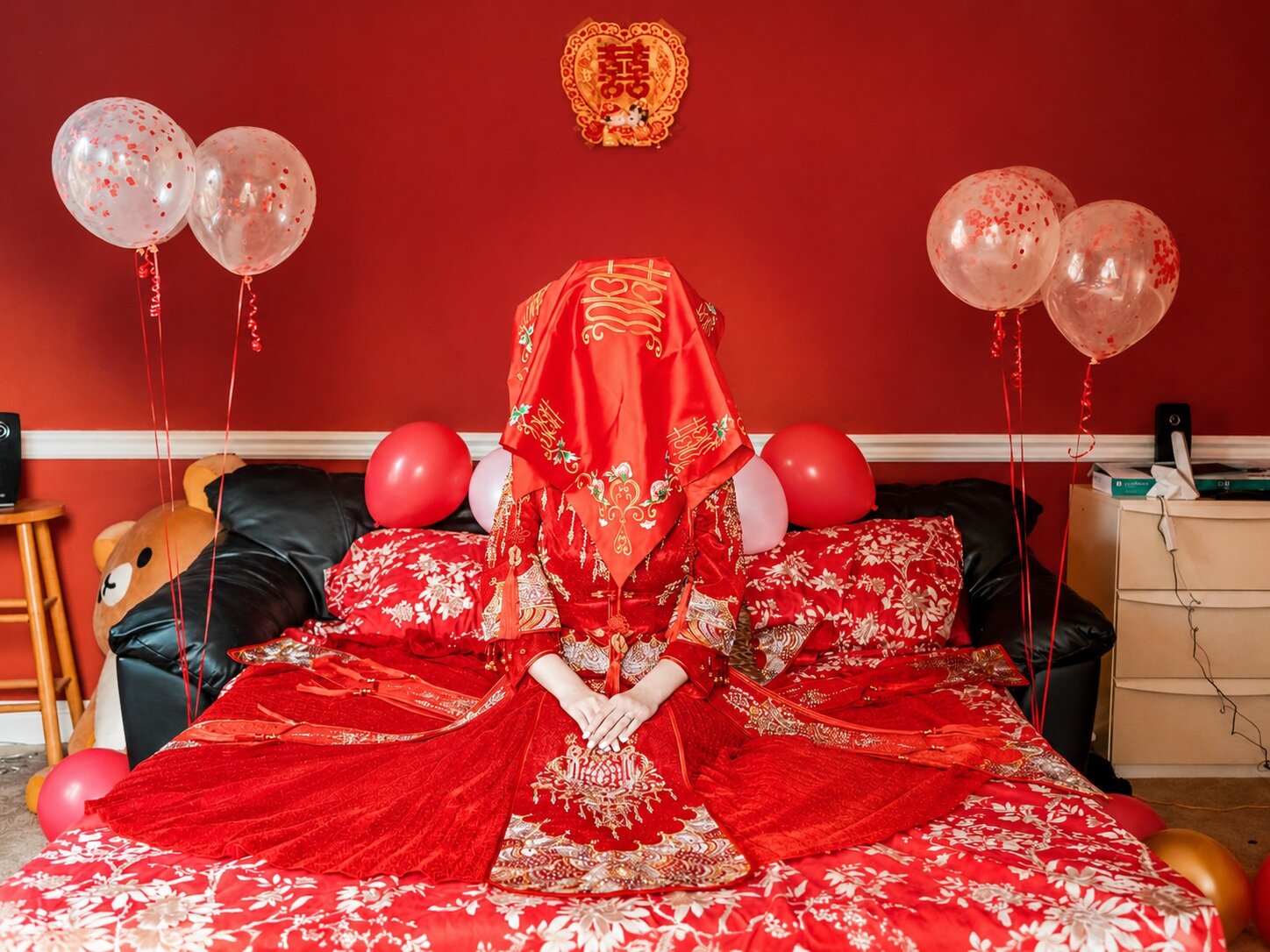 Bride sitting on a bed during a Chinese wedding