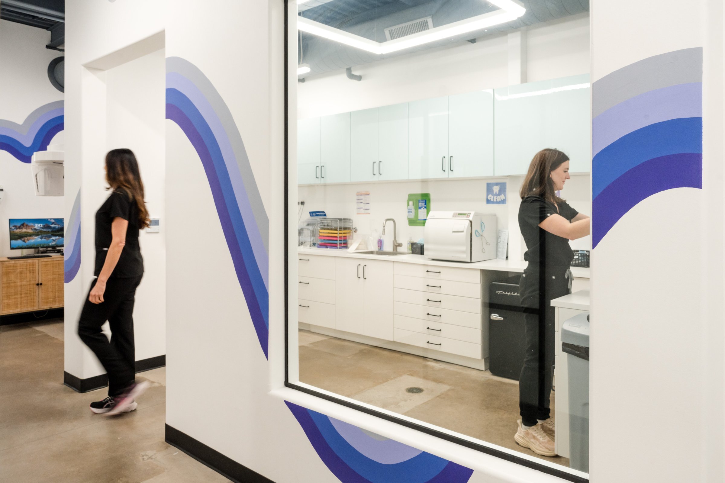 Drip Dental office hallway with team member, Dripping Springs dental practice