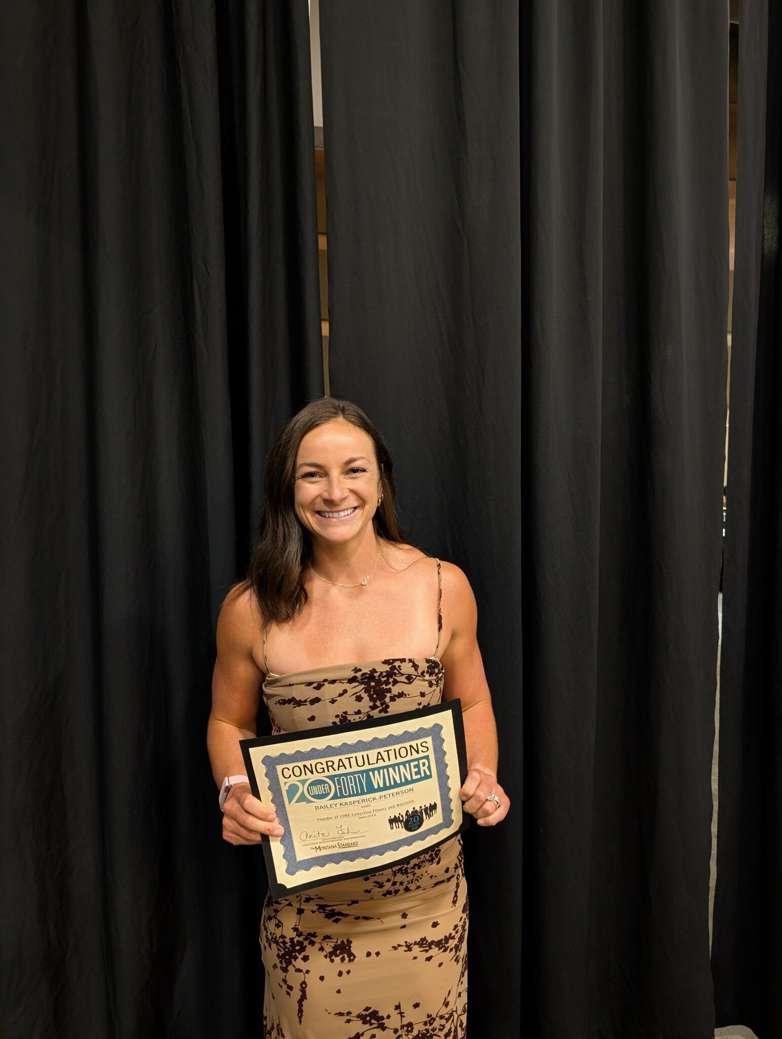 Bailey holding her 20 Under 40 honoree certificate