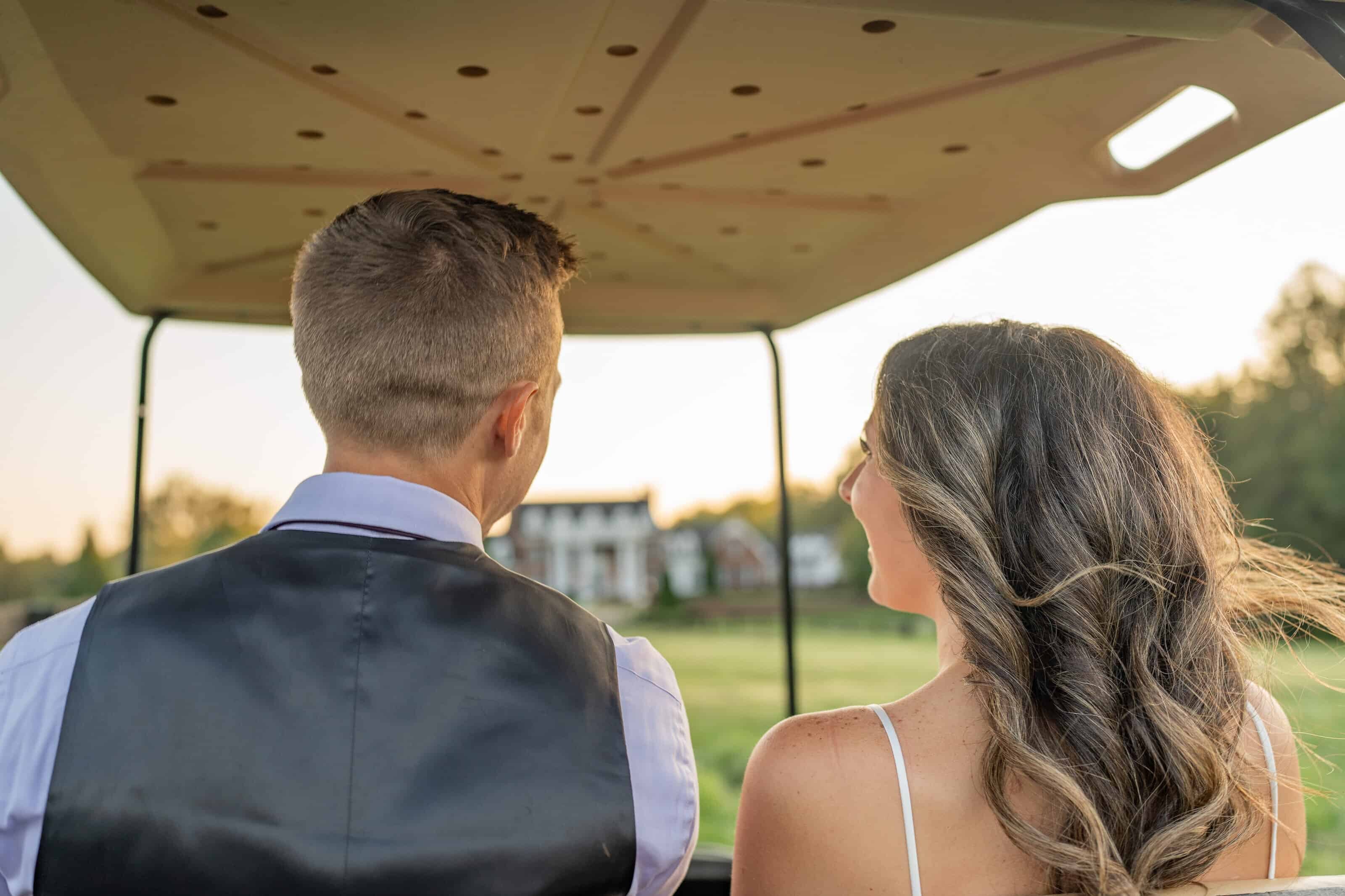Newlyweds driving away in a golf cart at a private estate wedding during a destination wedding