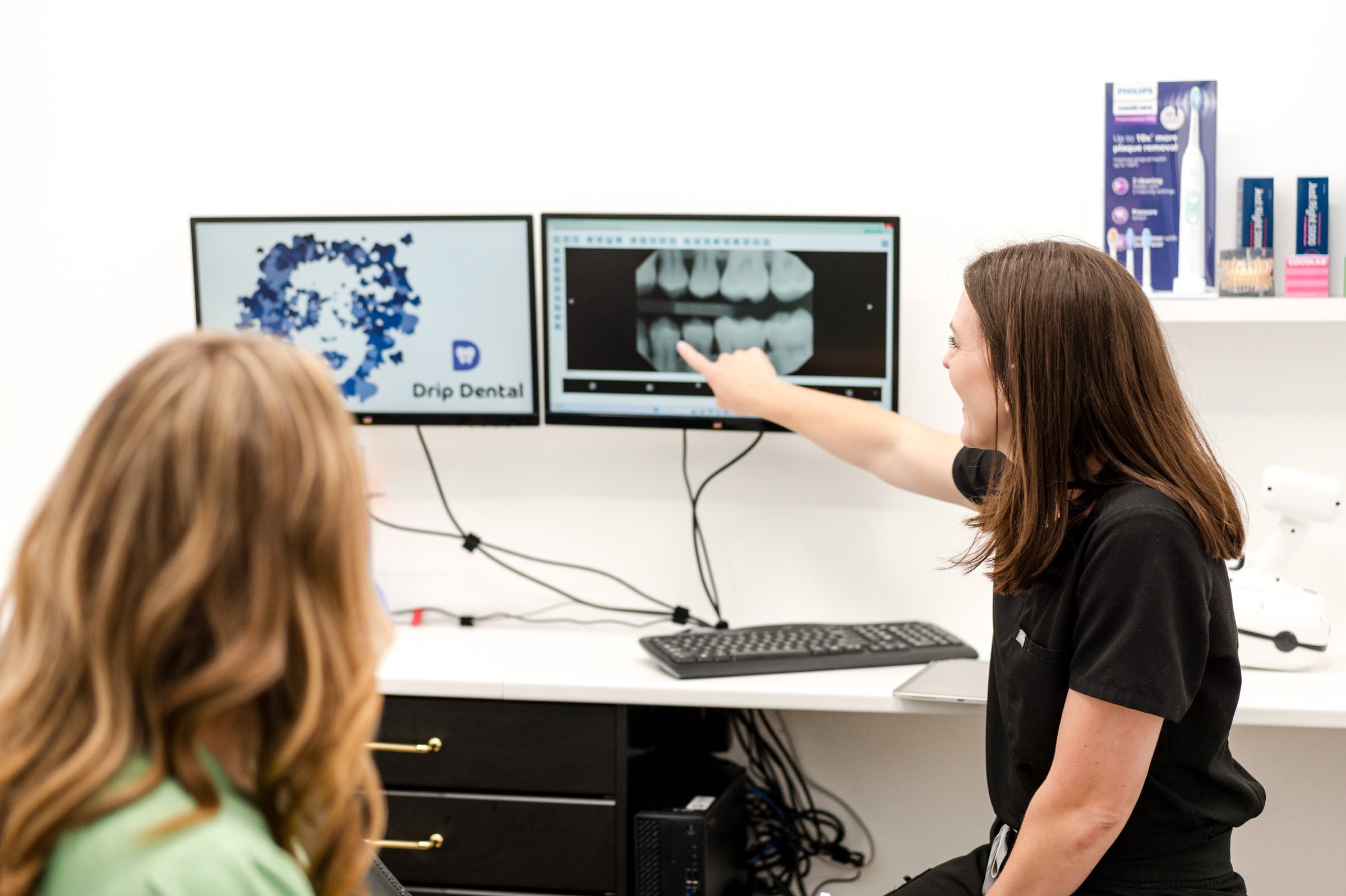 Drip Dental team member reviewing dental xray with patient, Dripping Springs dental office