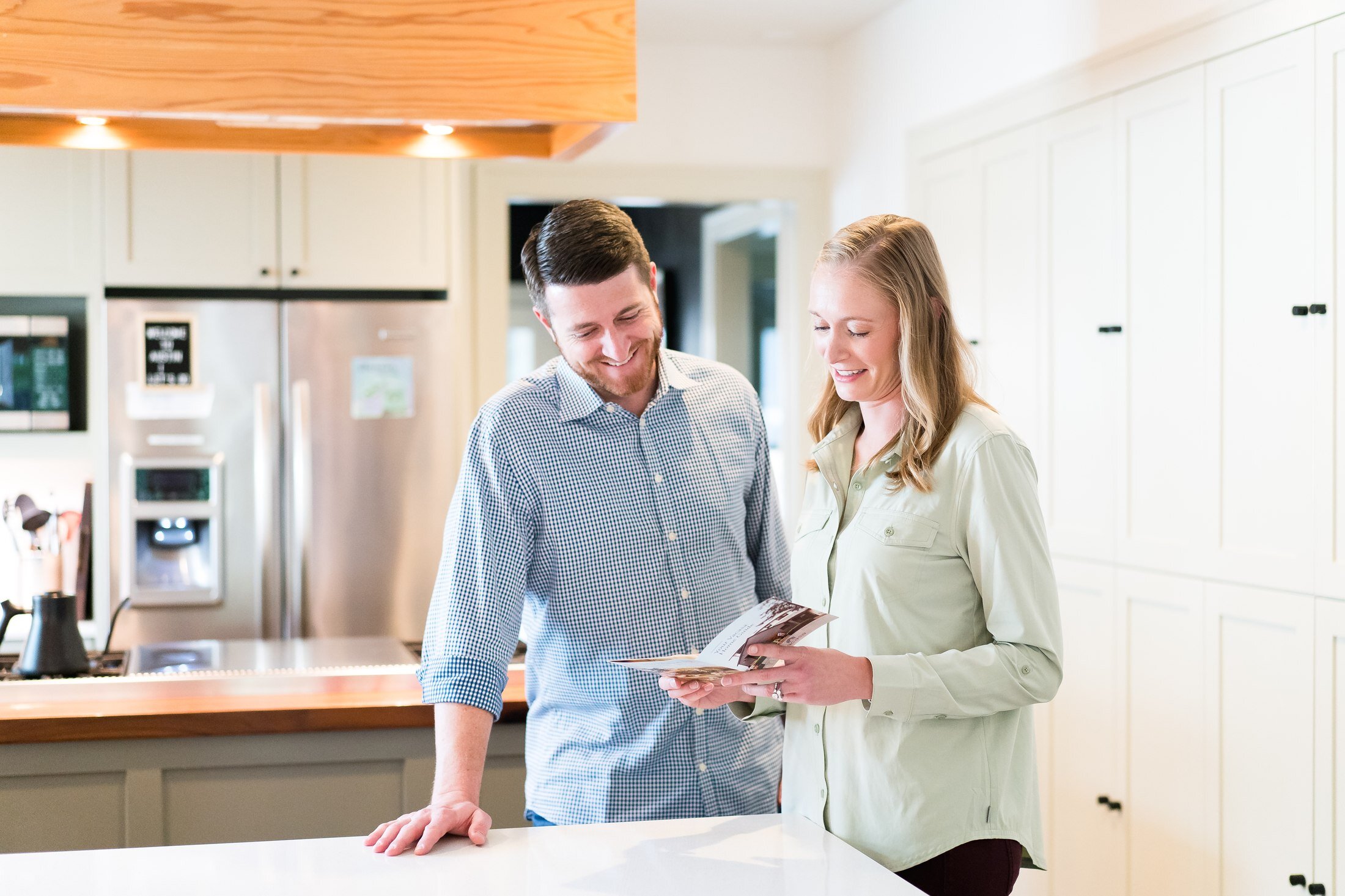 Guest reading the Vacasa vacation guide in the kitchen of an Austin rental