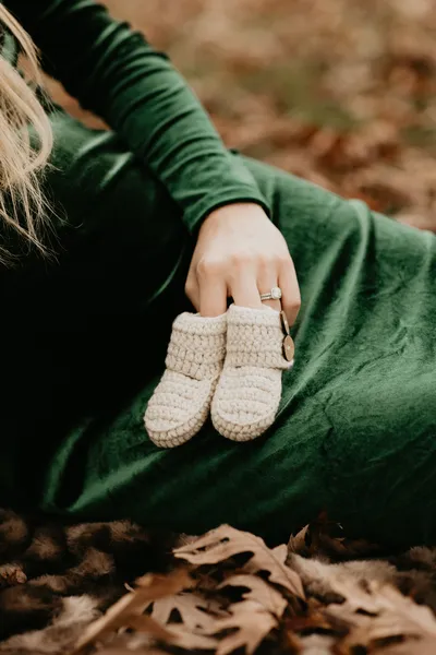Close up of a newborn's tiny knit booties, editorial newborn photography