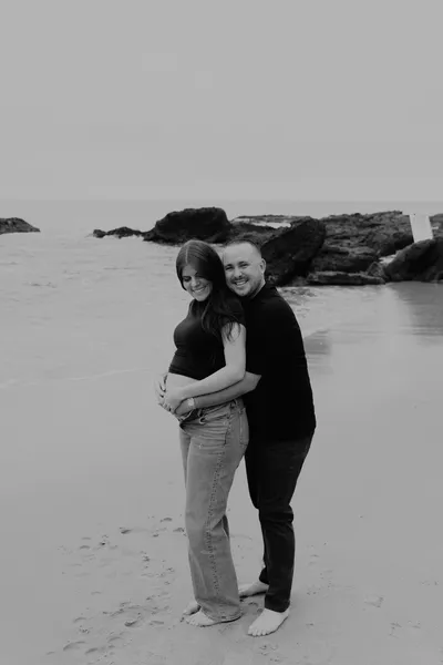 Couple embracing on the beach, black and white portrait