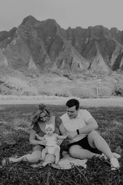 Parents with two children together, black and white extended family portrait