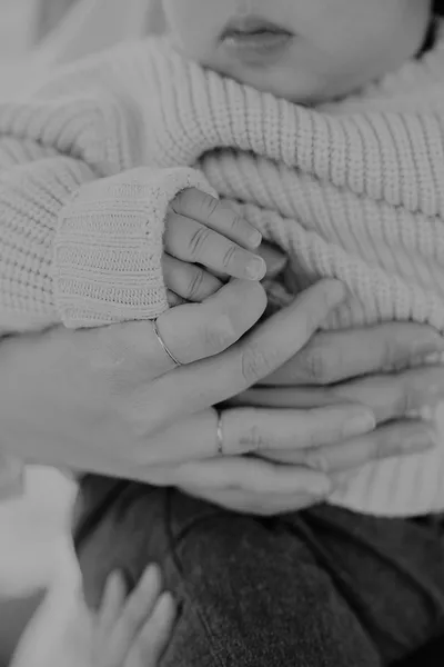 Mother cheek to cheek with her newborn baby, black and white in-home portrait