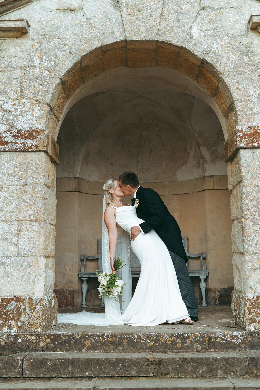 The couple in a stone arch in the garden