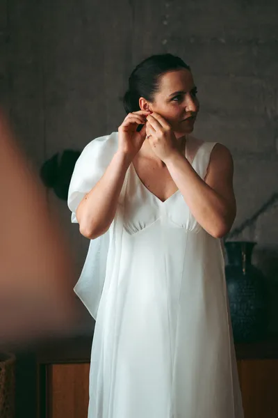Bride putting in her earrings