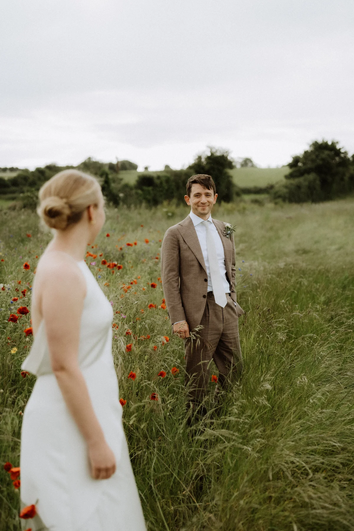 Couple walking across a field in Oxfordshire